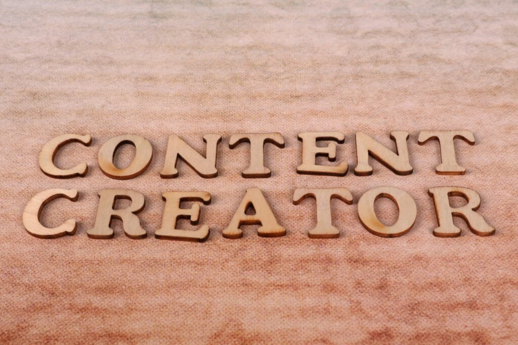 Wooden letters spelling 'Content Creator' arranged on a textured fabric background.